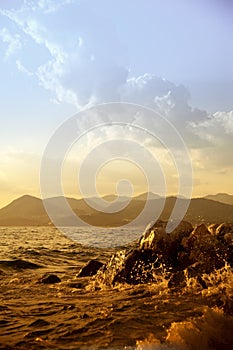 Rocky sea shore and dramatic sky at sunset