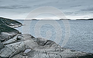 Rocky sea shore on an overcast day. Background for travel layouts