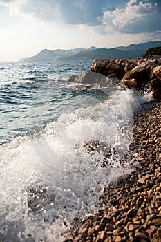 Rocky sea shore and waves splashing