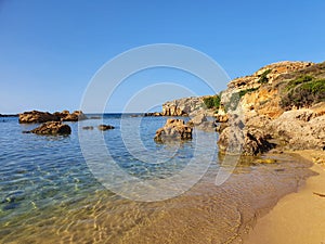 Rocky seashore with a blue sky and cristal clear watter

ï¿¼