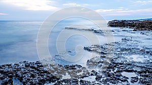 Rocky seashore and calm blue ocean