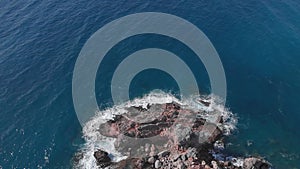 Rocky seashore landscape. Coastline with rocks and cliffs. Sea waves hitting rocky beach, crashing, splashing and creating white f