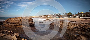 Rocky shore with Beach cottages lining Crystal Cove State Park b