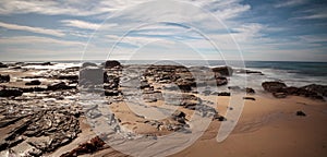 Rocky shore with Beach cottages lining Crystal Cove State Park b