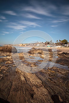 Rocky shore with Beach cottages lining Crystal Cove State Park b