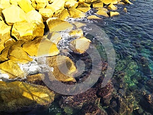 Rocky shore with clear blue water. Seashore with large boulders. Mediterranean Sea coast, Cyprus.