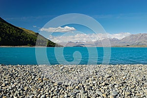 The rocky shore of Lake Tekapo, New Zealand