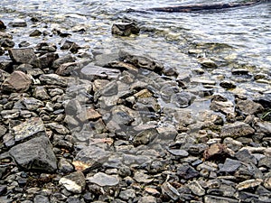 Rocky shore of lake Uvildy in inclement weather