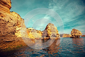 Rocky shore near Praia da Marinha beach and Benagil in Algarve region in Atlantic ocean, Portugal