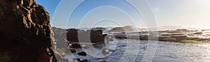 Rocky Shore on the Pacific Ocean Coast. Sunny Sunset. Nature Background