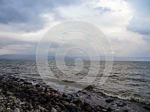 Rocky shore of the sea or lake.The sea of Galilee also called Lake Tiberias or Kinneret, Israel.