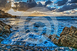 Rocky shore at sunset in Sardinia