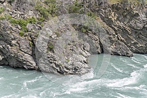 Rocky shore and turbulent waters at Kawarau river gorge, Otago, New Zealand