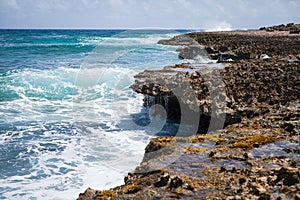 Rocky shoreline with crashing waves in aruba