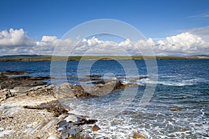 Rocky shoreline with distant hills