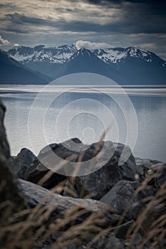 Rocky shoreline and mountains photo