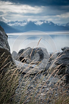 Rocky shoreline and mountains photo