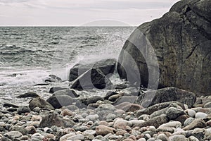 Rocky shoreline and tranquil with the ocean waves crashing against the beach