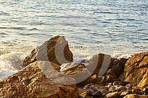 Rocky shoreline with water swirl and open ocean texture
