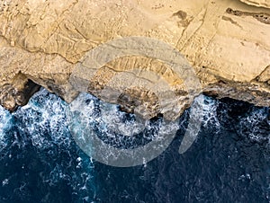 Rocky shores from above aerial snapshot revealing the island\'s untamed coastal allure