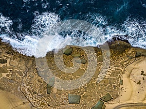 Rocky shores from above aerial snapshot revealing the island\'s untamed coastal allure