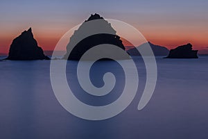 Rocky silhouettes in the Aegean Sea.