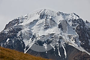 Rocky slope of mountain peaks, glaciers, snowfields