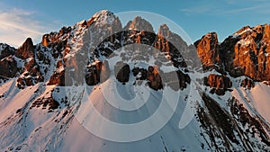 Rocky snow mountains at sunrise aerial