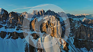 Rocky snow mountains at sunrise aerial