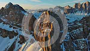 Rocky snow mountains at sunrise aerial