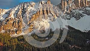 Rocky snow mountains at sunset aerial