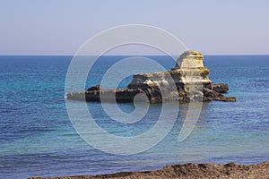 Rocky stacks on the coast of Salento in Italy photo