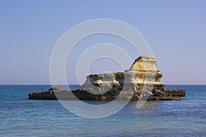 Rocky stacks on the coast of Salento in Italy photo