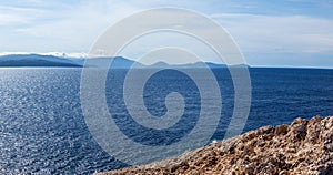 Rocky steep cliff panorama, blue Ionian seascape