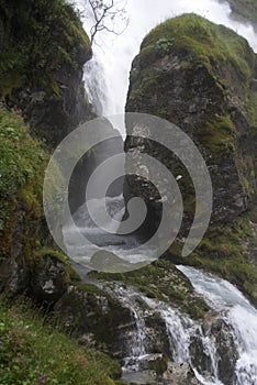 Rocky stream in a gorge aside of the waterfall