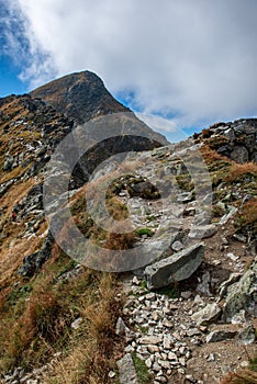 Rocky Tatra mountain tourist hiking trails under blue sky in Slovakia