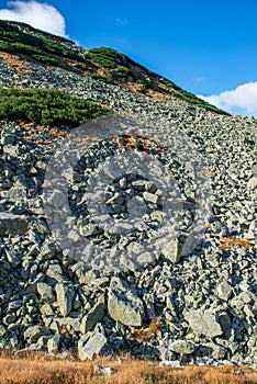 Rocky Tatra mountain tourist hiking trails under blue sky in Slovakia