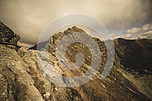 Rocky Tatra mountain tourist hiking trails under blue sky in Slovakia - vintage retro look