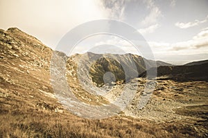 Rocky Tatra mountain tourist hiking trails under blue sky in Slovakia - vintage retro look