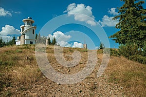 Rocky trail going to lighthouse on top of hill