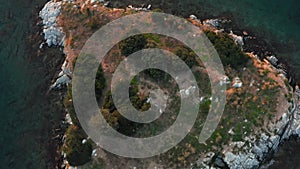 Rocky uninhabited island in the sea. Aerial view