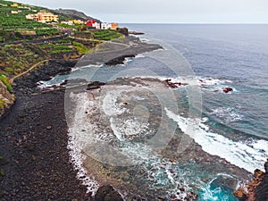 Rocky, volcanic beach and unsettled atlantic ocean. La Palma Island. Aerial view