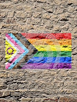 Rocky wall with a LGBT flag and intersexual flag painted on it photo