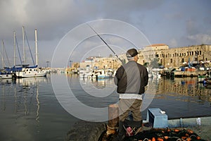 Rod fisherman in akko harbour