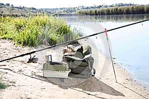 Rod and fishing essentials at riverside