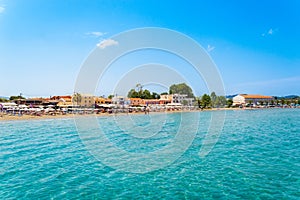 Roda tourist town on Corfu island, Greece. Beautiful village on seashore with colorful houses, beach bars and photo