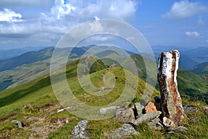 Rodna mountains in Romania - guard stone at the ridge photo