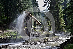 Rodna mountains in Romania - water wheel at Iza river source