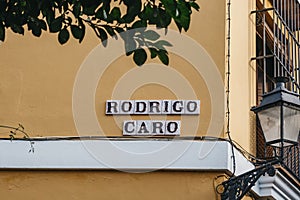 Rodrigo Caro street name sign on a street in Seville, Spain photo