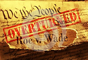 Roe V Wade newspaper headline with Overturned stamp on the United States Constitution